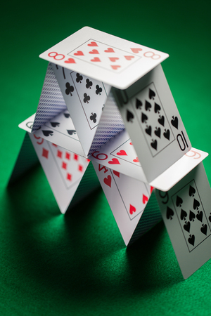 close up of house of playing cards on green clothの写真素材