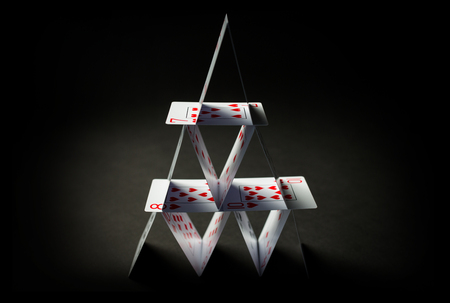 house of playing cards over black backgroundの写真素材