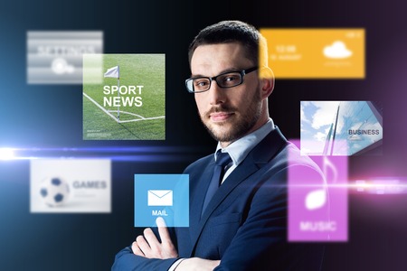 business, people and technology concept - businessman in glasses over black background with virtual...