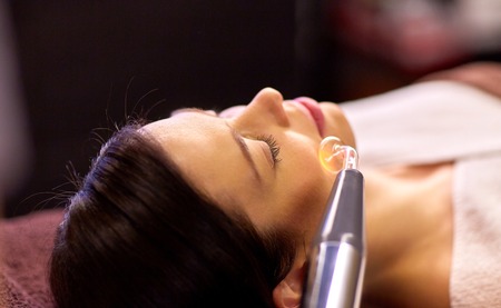woman having hydradermie facial treatment in spa