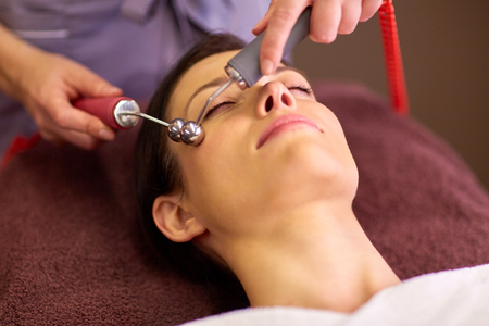 woman having hydradermie facial treatment in spa