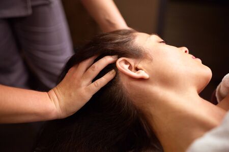 woman having head massage at spaの写真素材