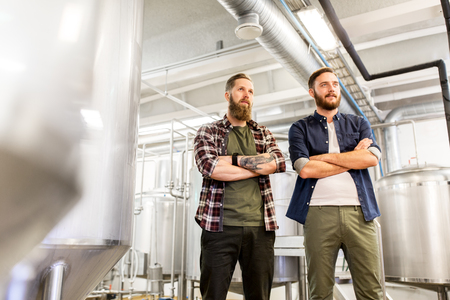 manufacture, business and people concept - men at craft brewery or beer plantの写真素材