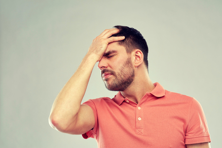 unhappy man suffering from head acheの写真素材