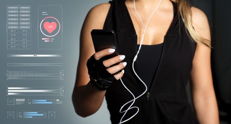 sportswoman with smartphone and earphonesの写真素材