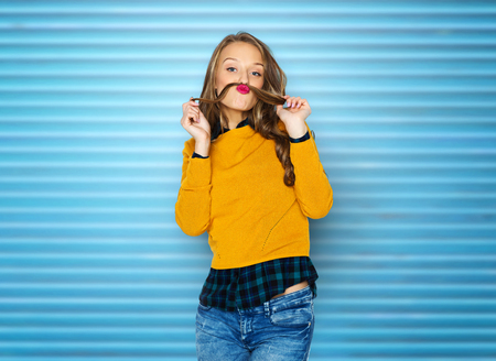happy young woman or teen girl in casual clothesの写真素材
