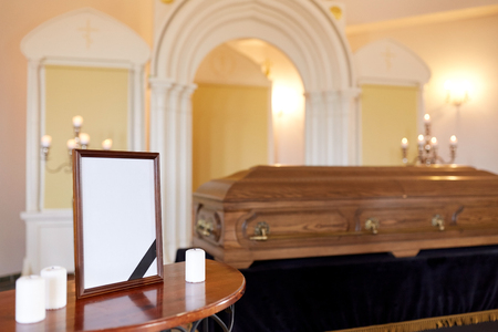 photo frame and coffin at funeral in churchの写真素材