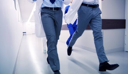 close up of medics or doctors running at hospitalの写真素材