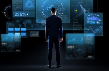 businessman looking at virtual screen from backの写真素材