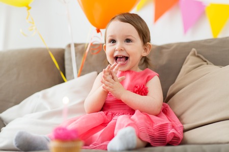 happy baby girl on birthday party at homeの写真素材