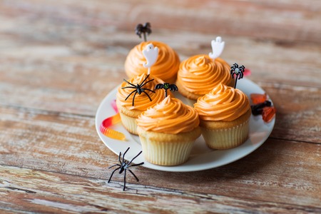halloween party cupcakes or muffins on tableの写真素材