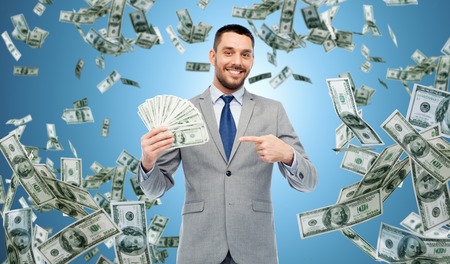 smiling businessman with american dollar moneyの写真素材