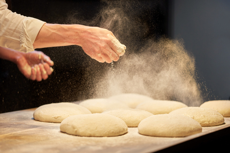 chef or baker cooking dough at bakeryの写真素材