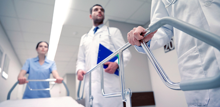 medics carrying hospital gurney to emergencyの写真素材