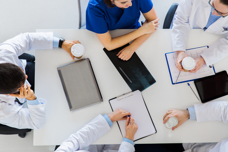 medicine, healthcare and people concept - group of doctors having coffee break at hospitalの写真素材