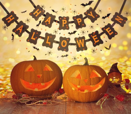 Carved pumpkins and happy halloween garlandの写真素材