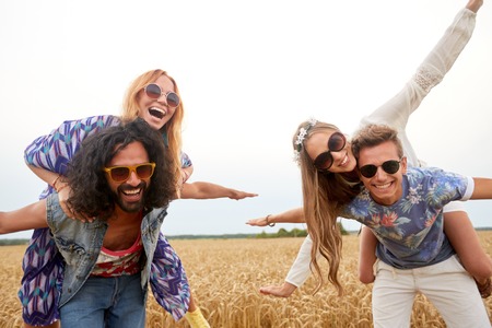 happy hippie friends having fun on cereal fieldの写真素材