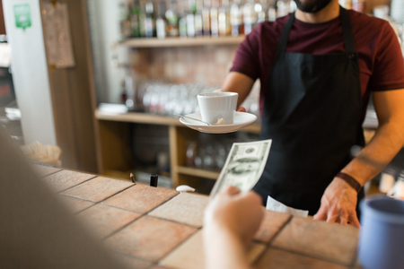 man or bartender serving customer at coffee shopの写真素材