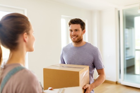 happy couple with boxes moving to new home
