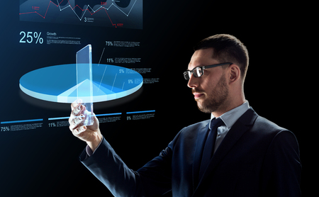 businessman with tablet pc and virtual chartsの写真素材