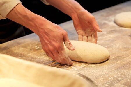 chef or baker cooking dough at bakery