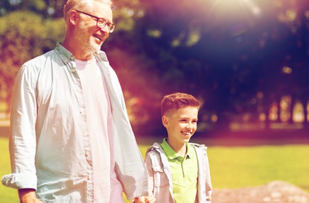 grandfather and grandson walking at summer parkの写真素材