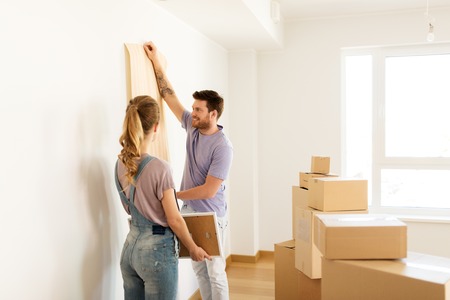 happy couple with boxes moving to new home