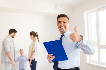 realtor with clipboard showing thumbs upの写真素材
