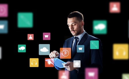 businessman with tablet pc and virtual menu iconsの写真素材