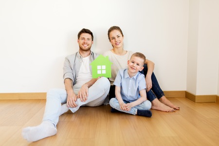 happy family with green house moving to new homeの写真素材