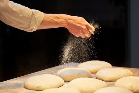 chef or baker making bread dough at bakeryの写真素材