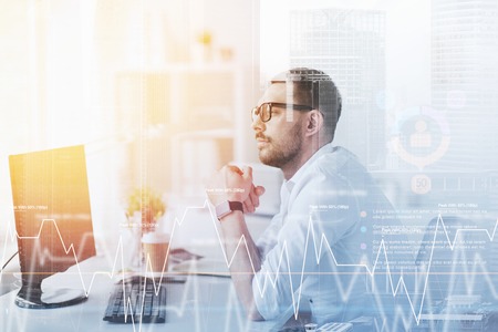 businessman in glasses sitting at office computer