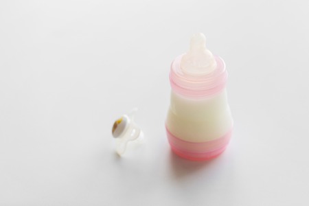 infant milk formula in baby bottle on tableの写真素材