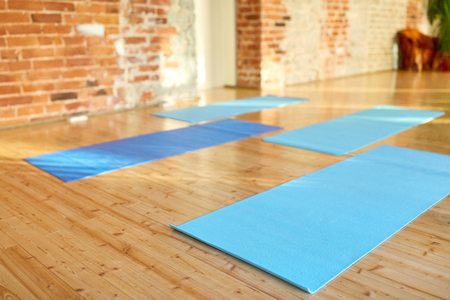 fitness, sport and healthy lifestyle concept - yoga mats on floor at gym or studioの写真素材