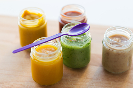 vegetable or fruit puree or baby food in jarsの写真素材
