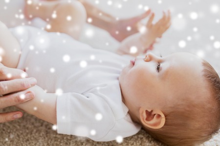 close up of happy little baby and mother handsの写真素材