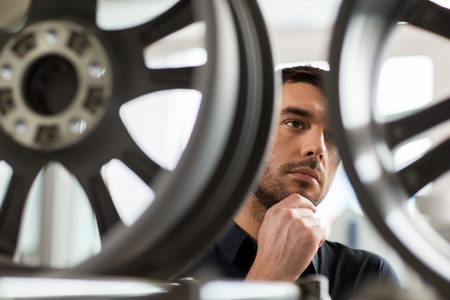 male customer choosing wheel rims at car serviceの写真素材