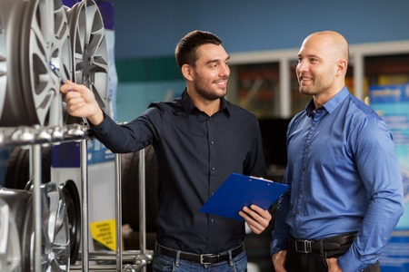 customer and salesman at car service or auto storeの写真素材