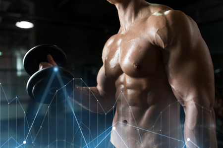 close up of man with dumbbells exercising in gymの写真素材