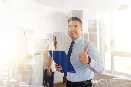 realtor with clipboard showing thumbs upの写真素材