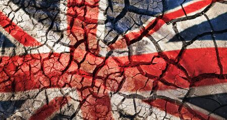 flag of great britain on cracked ground backgroundの写真素材