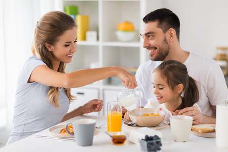 happy family having breakfast at homeの写真素材