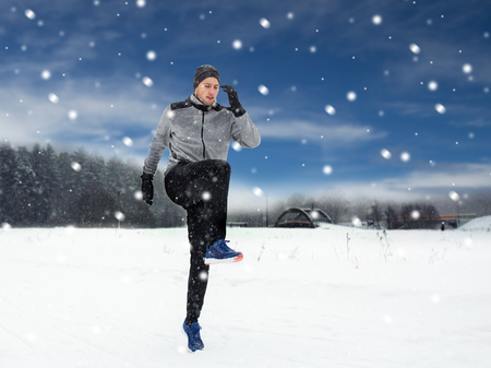 man exercising and warmig up in winter outdoorsの写真素材
