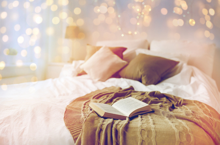 bedroom with bed and christmas garland at homeの写真素材