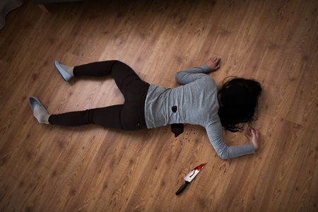 dead woman body lying on floor at crime sceneの写真素材