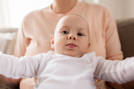 close up of mother with little baby boy at homeの写真素材