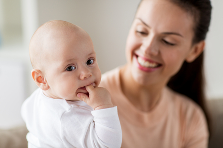 happy mother with little baby boy at homeの写真素材