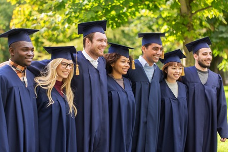 happy students or bachelors in mortar boardsの写真素材