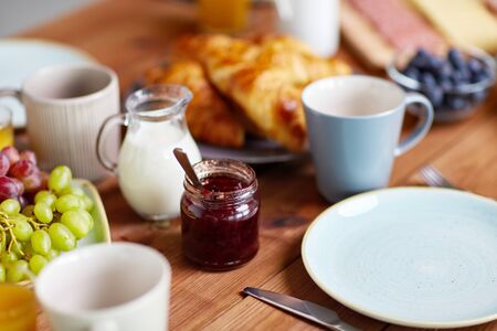 jar with jam on wooden table at breakfastの写真素材