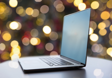laptop and coffee cup on table at christmasの写真素材